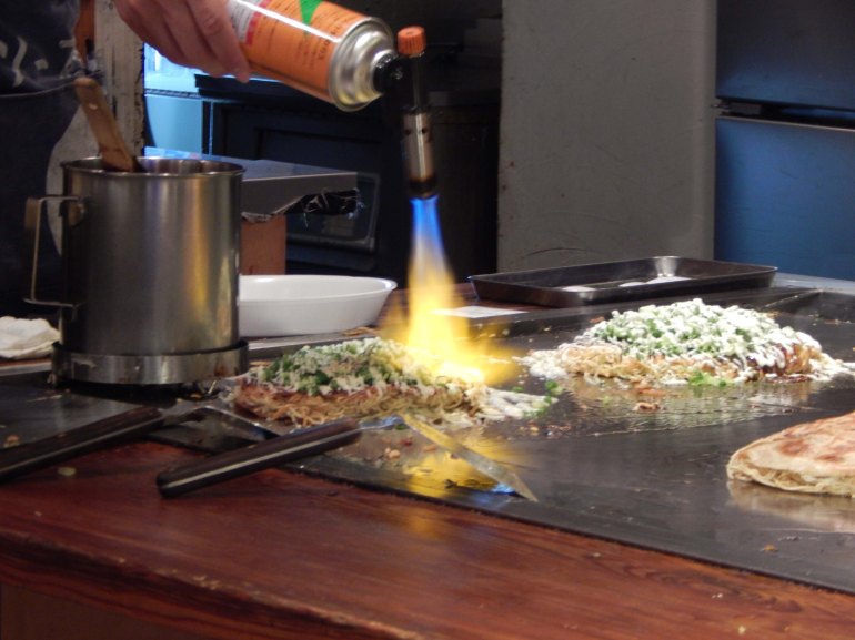 Finishing touches Okonomiyaki pancakes